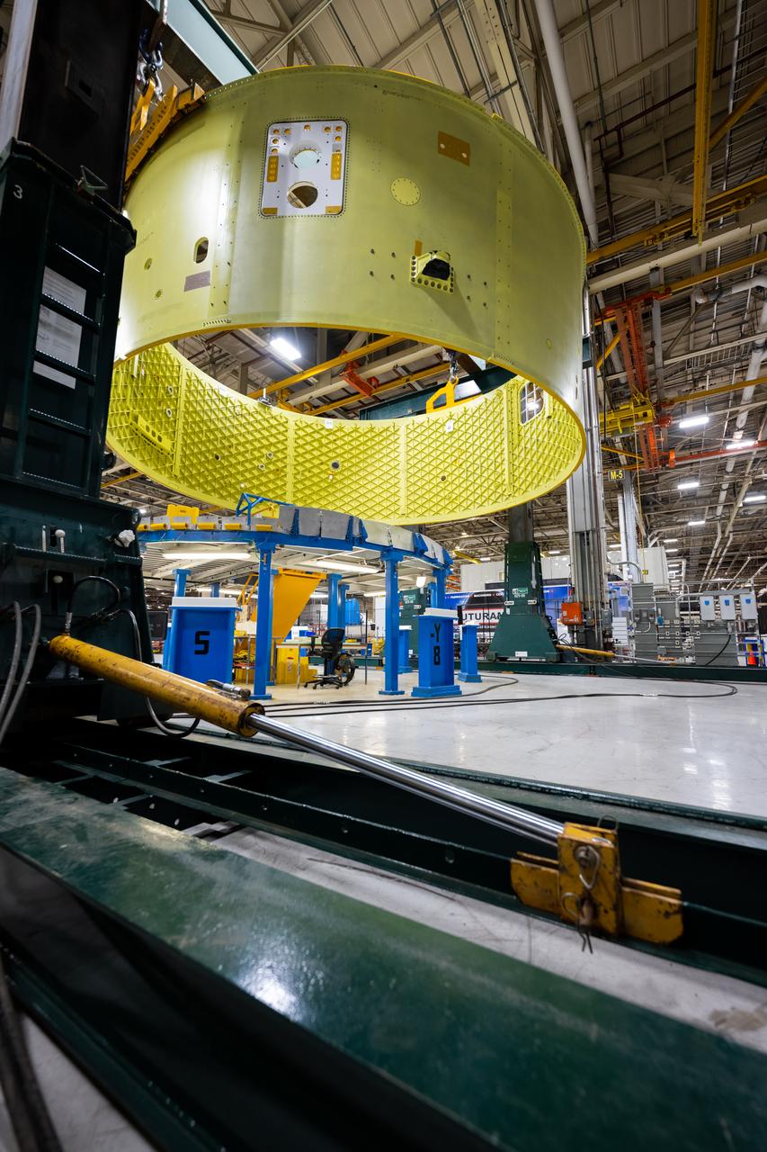Crews at NASA’s Michoud Assembly Facility in New Orleans move the forward skirt of NASA’s Space Launch System (SLS) rocket to another part of the facility Dec. 15. Teams are preparing to apply the thermal protection system to the flight hardware, which will protect it from the extreme temperatures during launch and flight. The forward skirt is part of the core stage that will power the SLS rocket for the Artemis III mission. The forward skirt houses flight computers, cameras, and avionics.. The SLS core stage is made up of five unique elements: the forward skirt, liquid oxygen tank, intertank, liquid hydrogen tank, and the engine section. When fully stacked, the forward skirt is located at the top of the core stage and connects the stage to the upper part of the rocket. Together with its four RS-25 engines, the rocket’s massive 212-foot-tall core stage — the largest stage NASA has ever built — and its twin solid rocket boosters produce 8.8 million pounds of thrust to send NASA’s Orion spacecraft, astronauts and supplies beyond Earth’s orbit to the Moon and, ultimately, Mars. Offering more payload mass, volume capability and energy to speed missions through space, the SLS rocket, along with NASA’s Gateway in lunar orbit, the Human Landing System, and Orion spacecraft, is part of NASA’s backbone for deep space exploration and the Artemis lunar program. No other rocket is capable of carrying astronauts in Orion around the Moon in a single mission.